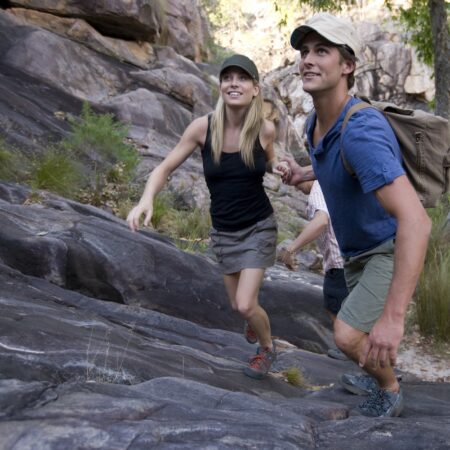 Couple hiking Gunlom Falls in Kakadu National Park, NT on our Northern Territory tours