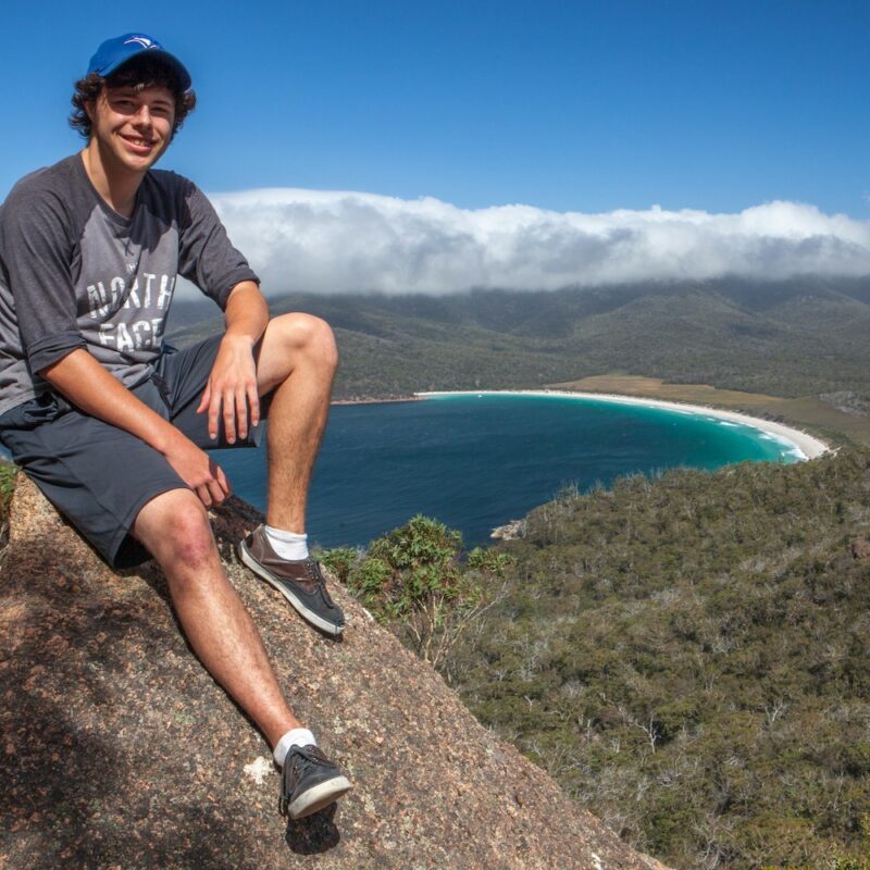 Sitting at Wineglass Bay Lookout Tasmania on our Wineglass Bay tour in Tasmania.