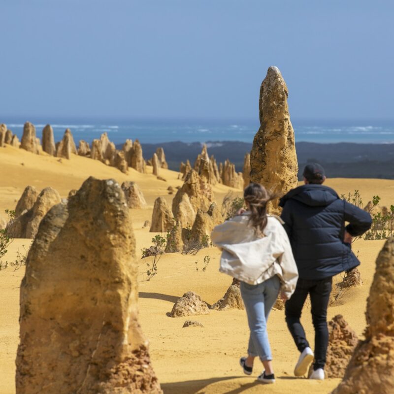 Couple walking in the Pinnacles desert on our Pinnacles Tours