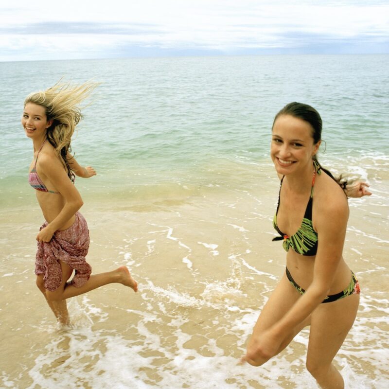 Girls running on the beach Shark Bay on our Perth to Exmouth tour. Western Australia