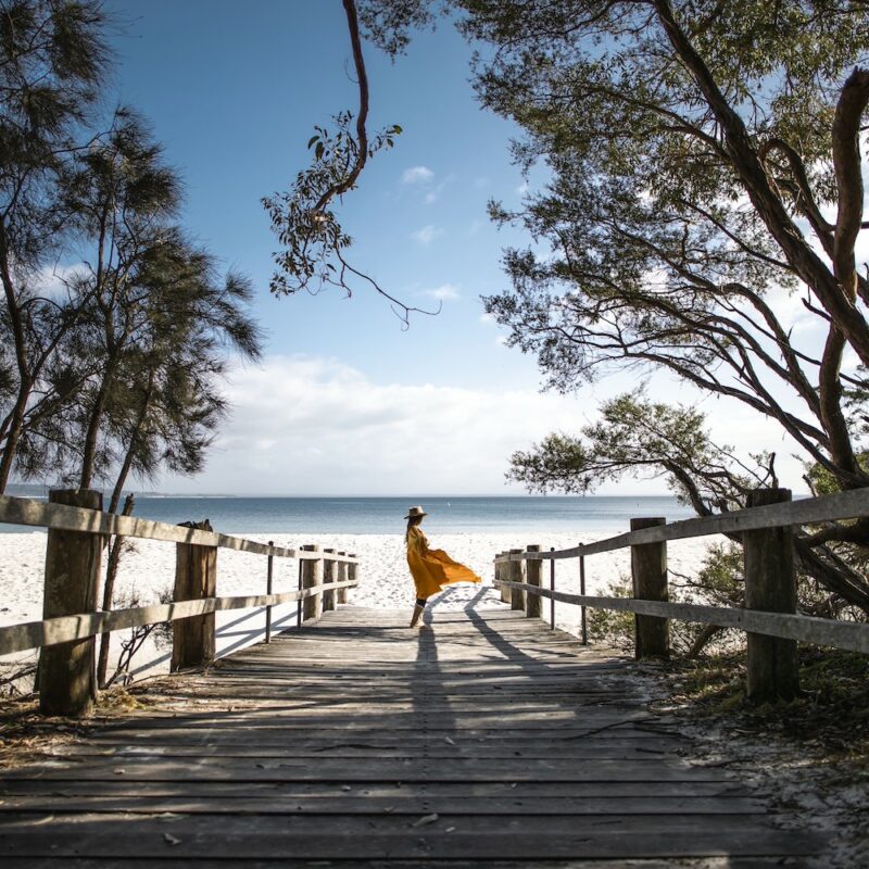 Girl walking to the beach at Jervis Bay Jump on board and come visit Jervis Bay with us.