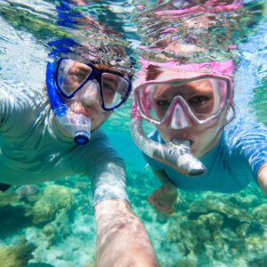 Couple Snorkelling Great Barrier Reef. on our great barrier reef day tours. family tours australia