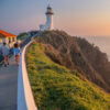 Walking up to a lighthouse at sunrise. BYRON BAY LIGHTHOUSE SUNRISE, Australia on our East Coast Sydney to Cairns Tour