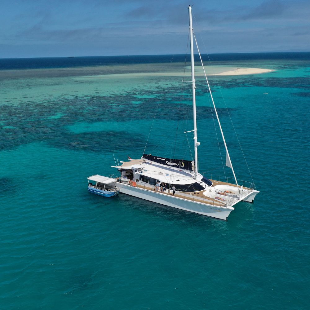 Real Aussie Adventures, Small Group Adventure Tours Australia. Mackay Sailaway VII boat View of the boat and Great Barrier Reef on our Port Douglas tours.