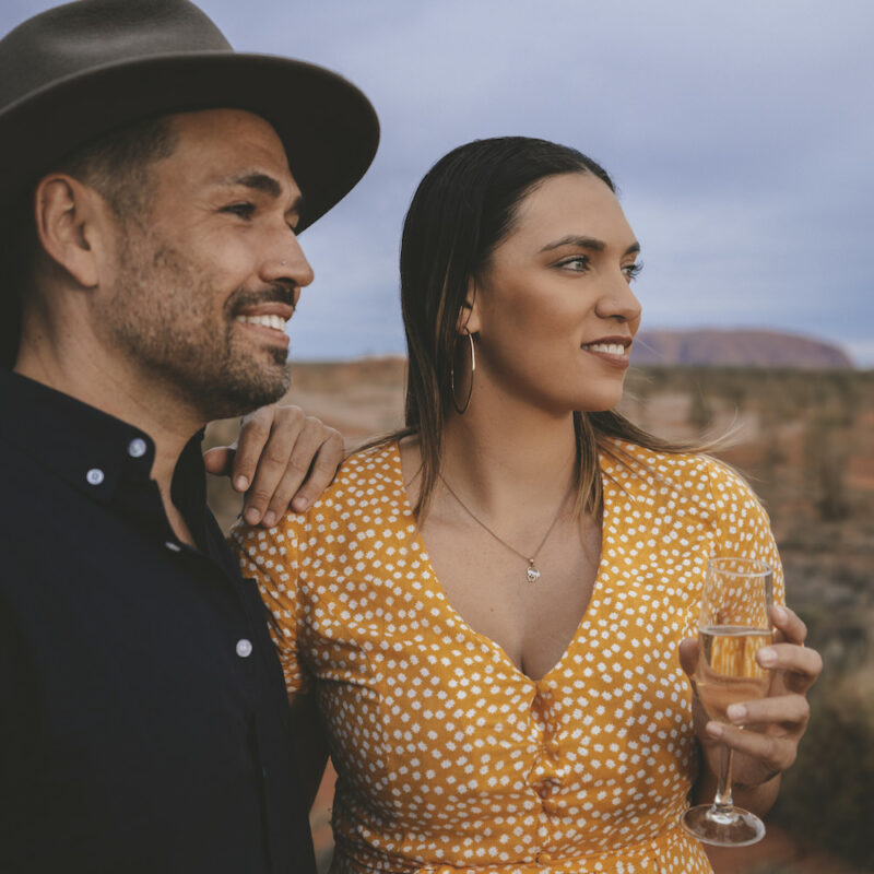 Real Aussie Adventures, Small Group Adventure Tours Australia. Couple enjoying a sunset drink at Uluru