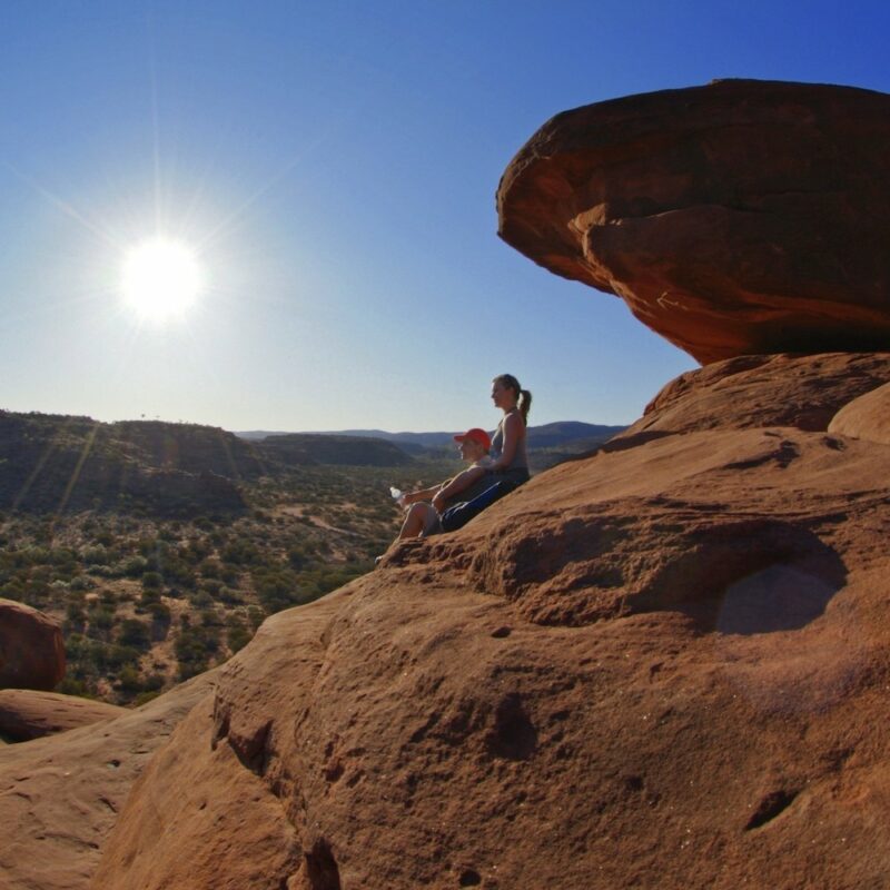 Visitors looking out over Palm Valley. The Finke Gorge National Park. Red Centre tours, Australia.