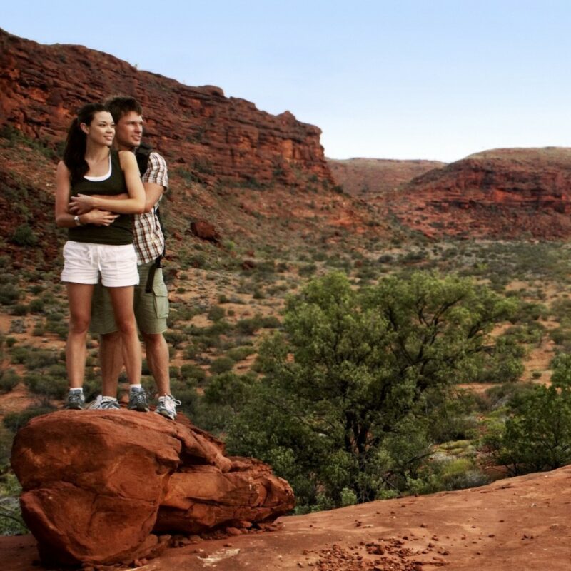 Couple Surrounded in Palm Valley on tour on our Red Centre tours, Australia.