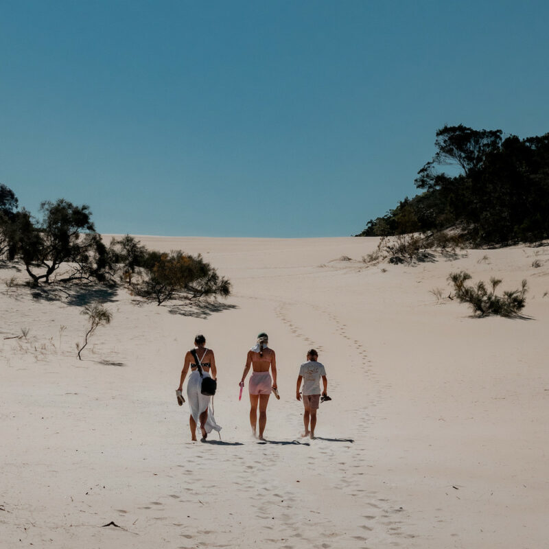 Real Aussie Adventures, Small Group Adventure Tours Australia. Family walking over the sand dunes at K'gari (Fraser Island) on Fraser Island tour