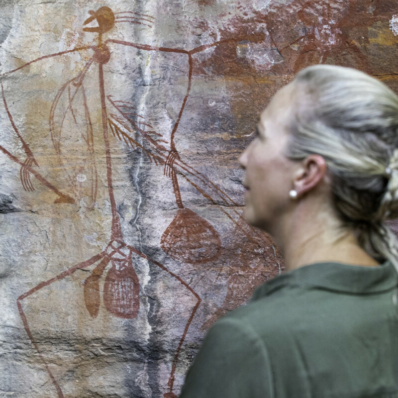 Woman looking at rock art at Ubirr on our 4 day Kakadu National Park Tour from Darwin