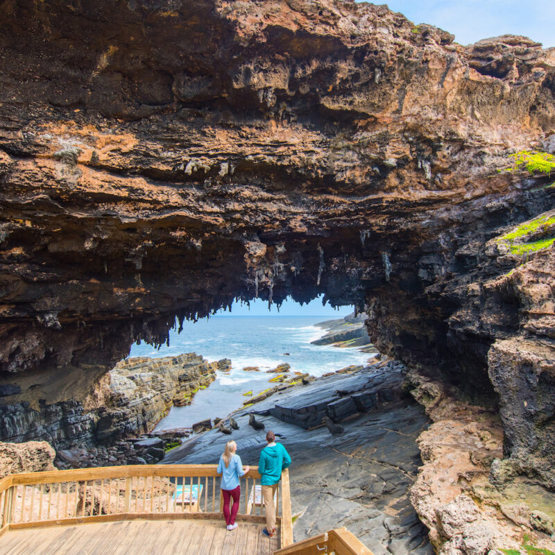 Real Aussie Adventures, Small Group Adventure Tours Australia. A Couple at Admirals Arch on tour in Kangaroo Island.