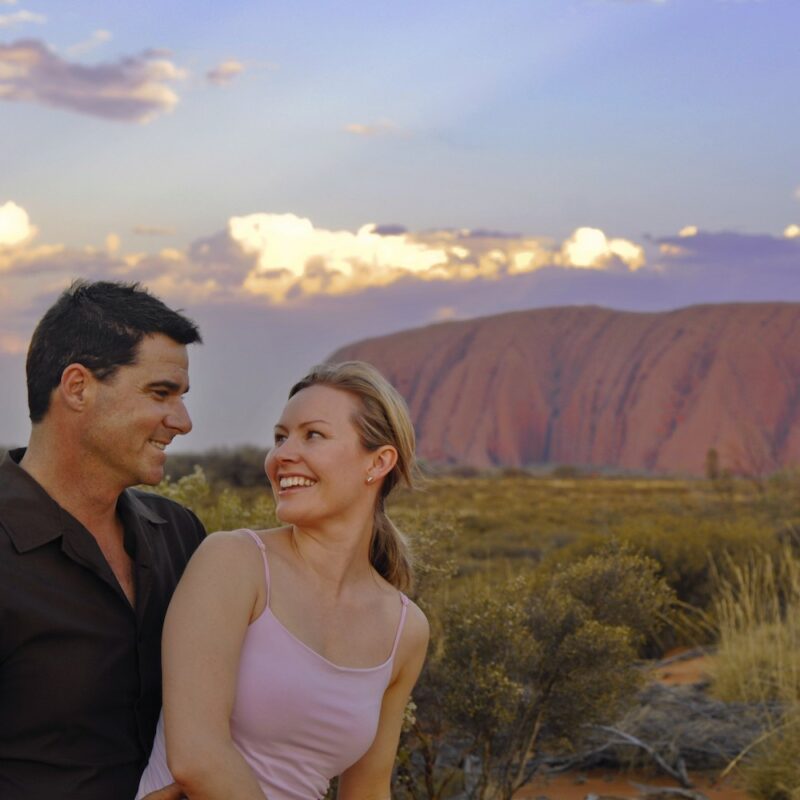 Couple at Uluru. NT Uluru Kata Tjuta National Park Northern Territory Tours.