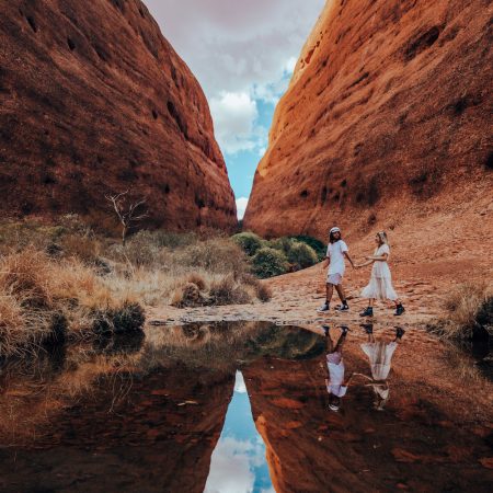Exploring Walpa Gorge, a couple walking on our Uluru to Adelaide Tour exploring
