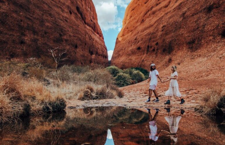 Exploring Walpa Gorge, a couple walking on our Uluru to Adelaide Tour exploring