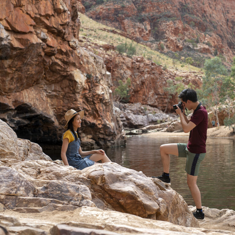 Man taking a photo of woman at Ormiston Gorge